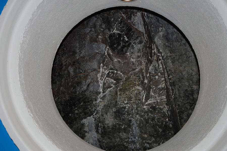 The décor and lighting elements contrast with bare rock face inside machine hall.